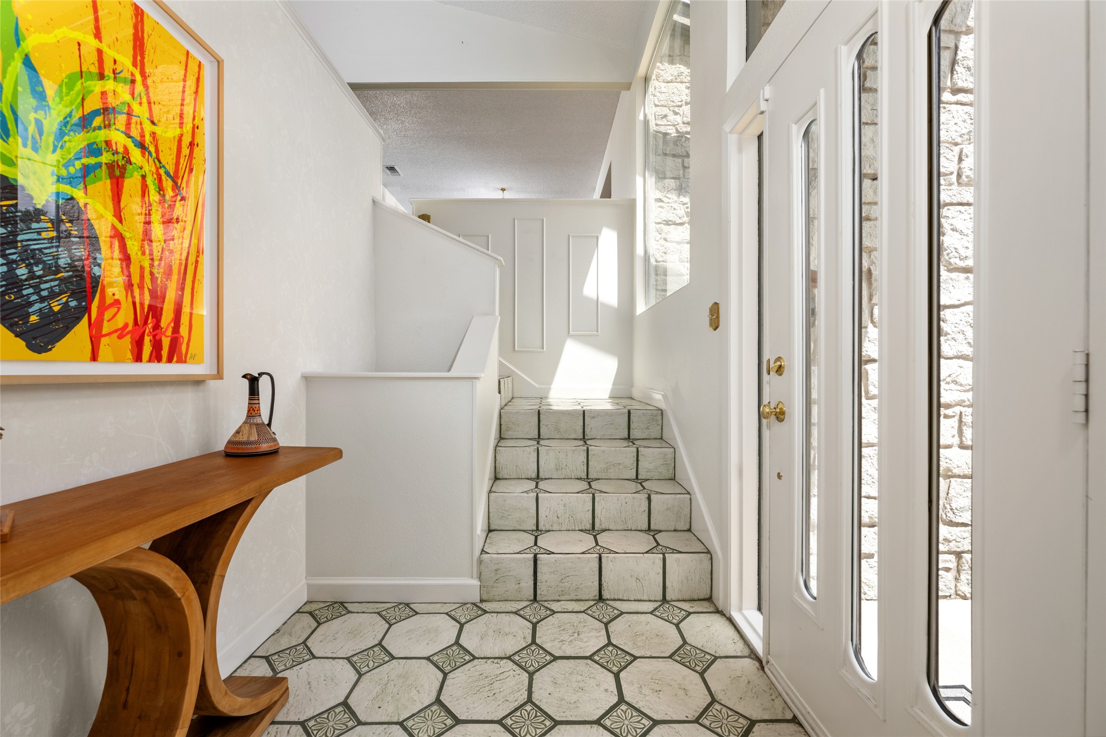 5319 Musket Ridge Austin, TX 78759 - Photo 6 of 39 Enter into a bright foyer with patterned tile flooring and stone-clad walls, leading to a multi-level layout.