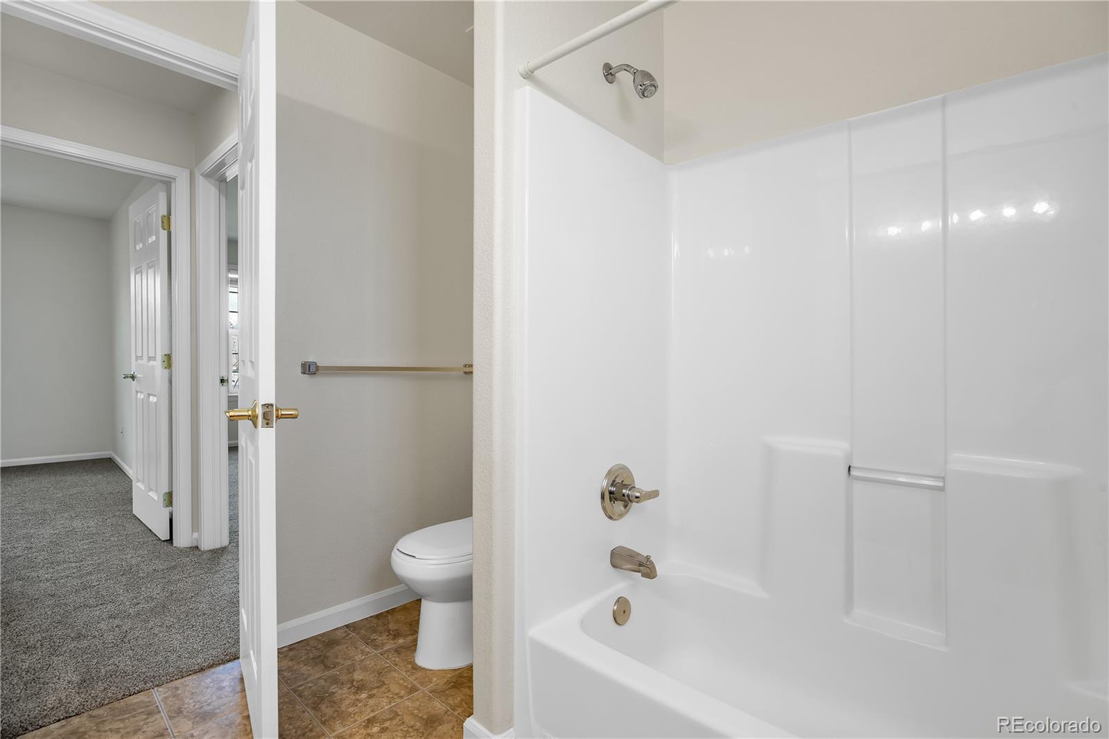 4505 Simms Court Wheat Ridge, CO 80033 - Photo 24 of 37 a bathroom with a bathtub and toilet