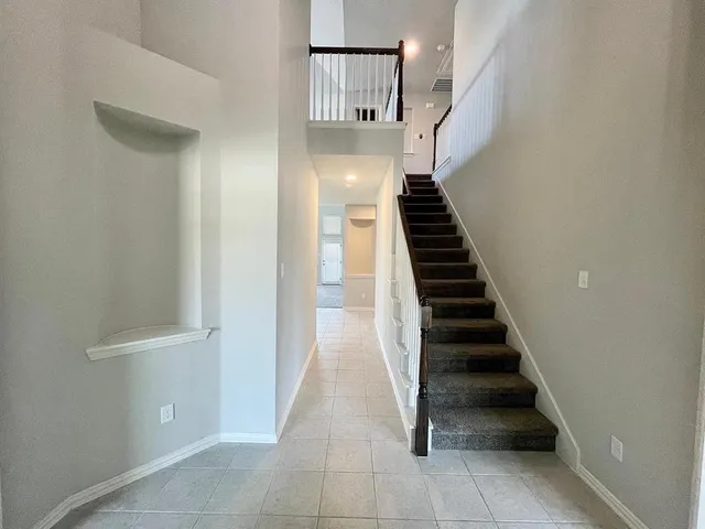 a view of entryway and hall with wooden floor