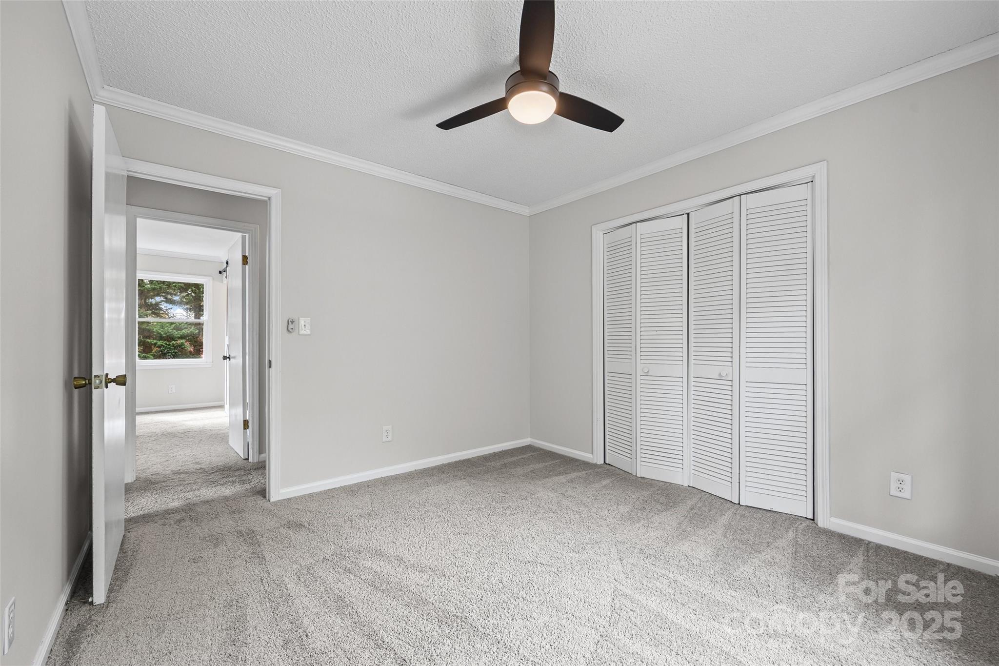 9111 Windjammer Drive Tega Cay, SC 29708 - Photo 18 of 36 a view of an empty room and chandelier fan