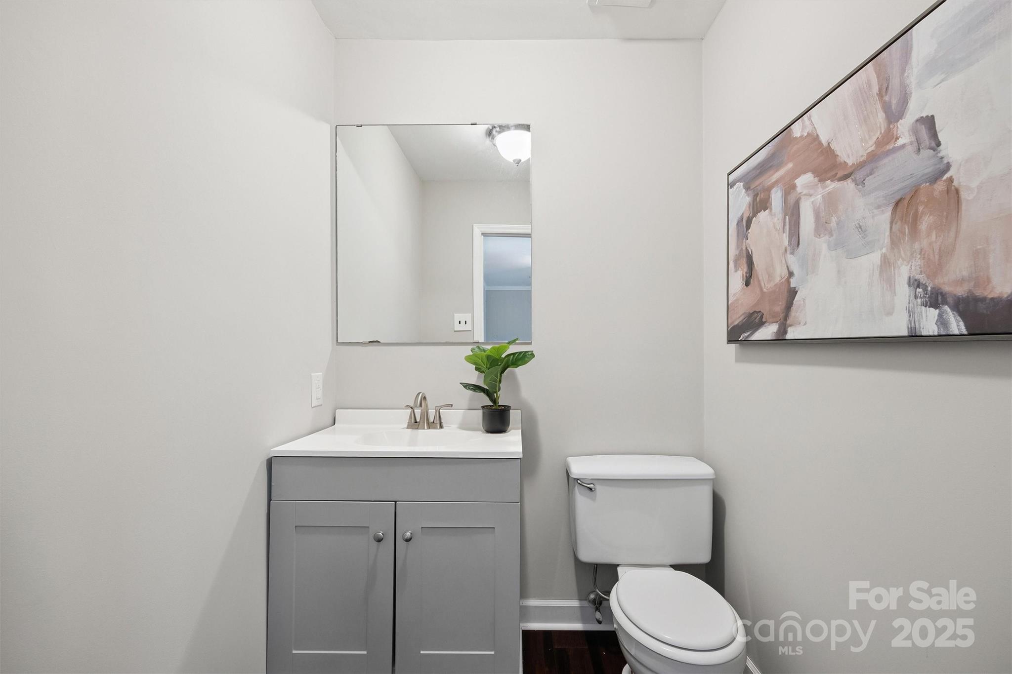 9111 Windjammer Drive Tega Cay, SC 29708 - Photo 22 of 36 a bathroom with a toilet sink and mirror