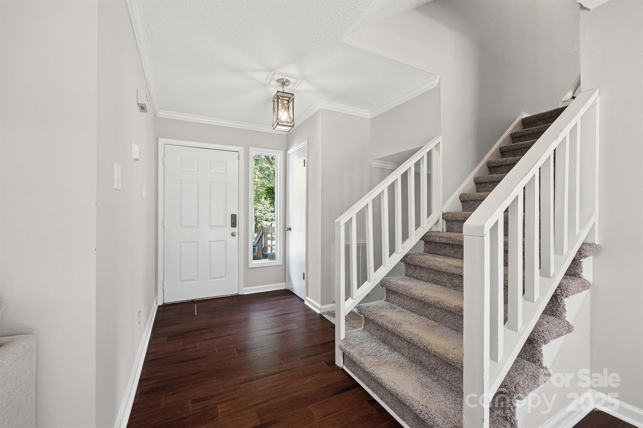 9111 Windjammer Drive Tega Cay, SC 29708 - Photo 3 of 36 a view of a hallway with wooden floor and entryway