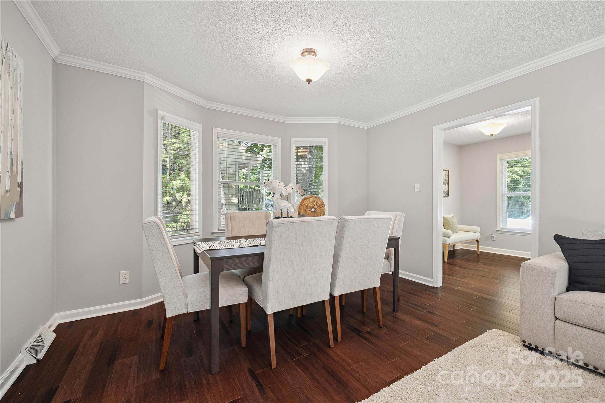 9111 Windjammer Drive Tega Cay, SC 29708 - Photo 6 of 36 a view of a dining room with furniture window and wooden floor