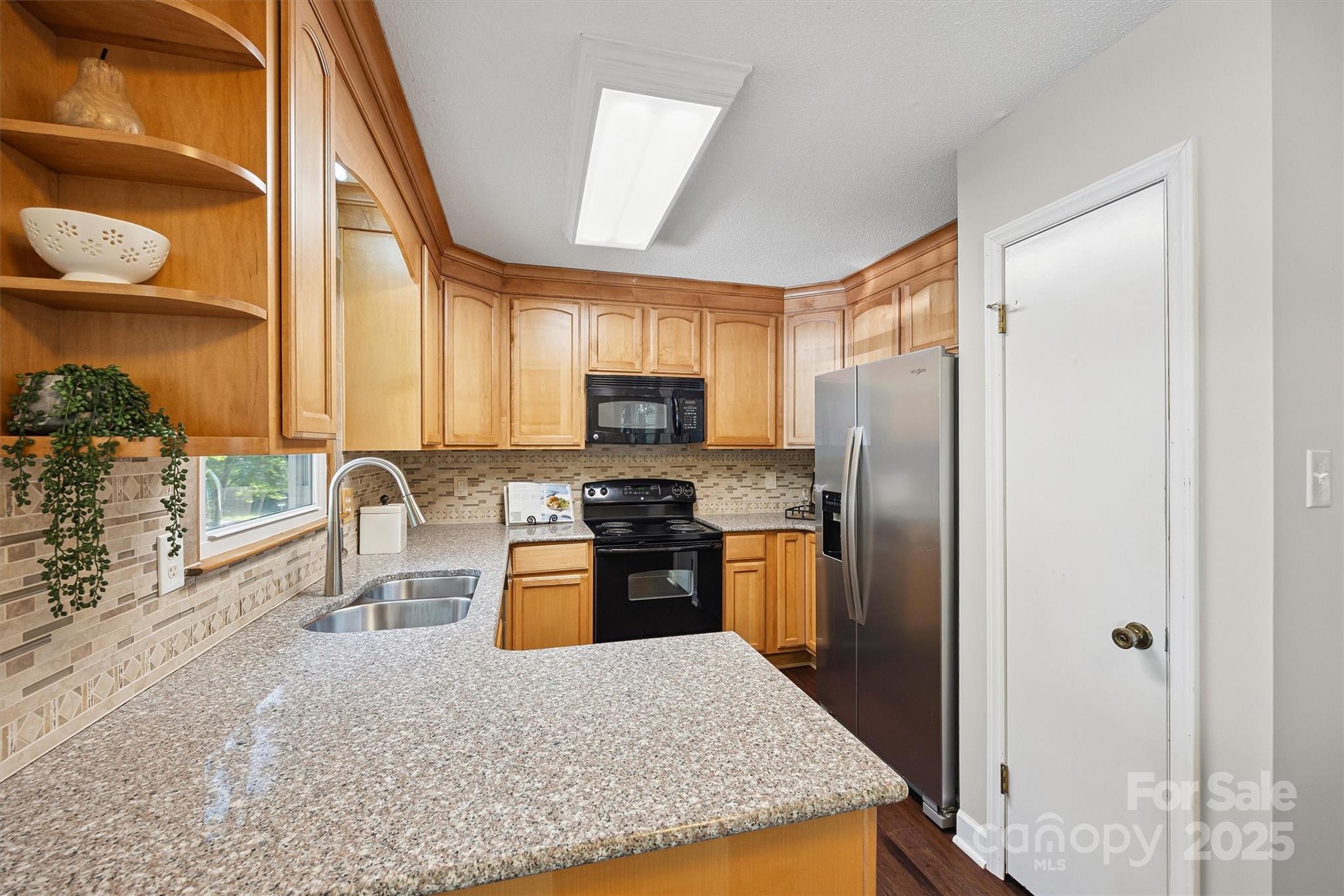 9111 Windjammer Drive Tega Cay, SC 29708 - Photo 9 of 36 a kitchen with stainless steel appliances granite countertop a refrigerator a stove top oven a sink and dishwasher