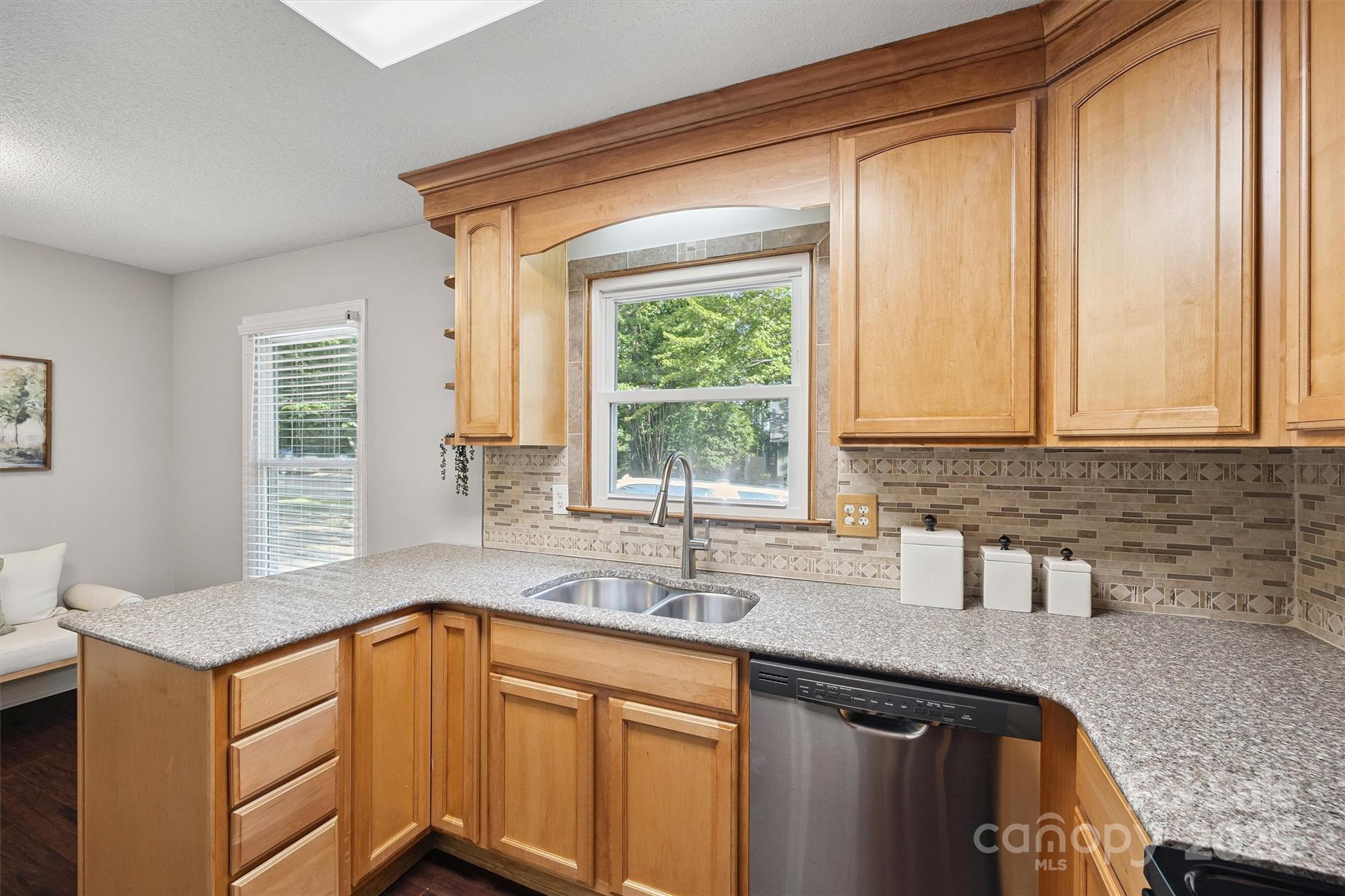 9111 Windjammer Drive Tega Cay, SC 29708 - Photo 10 of 36 a kitchen with stainless steel appliances granite countertop a sink and a window
