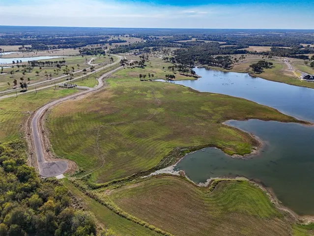 an aerial view of residential houses with outdoor space and swimming pool