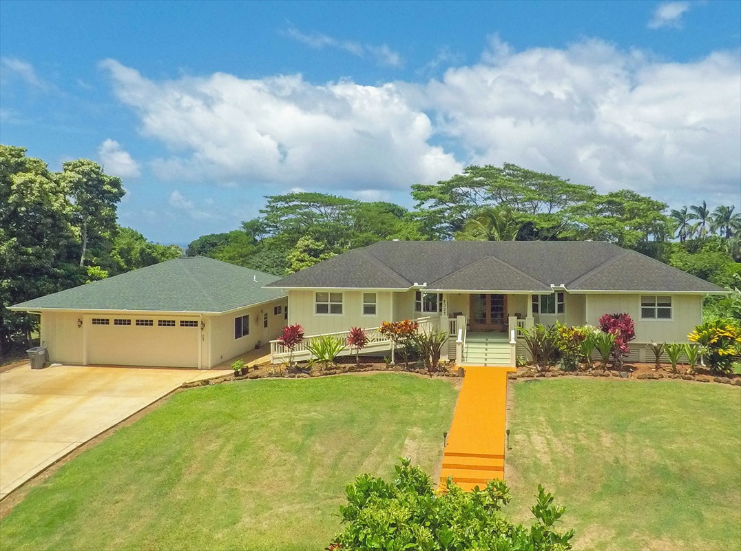 a front view of a house with garden