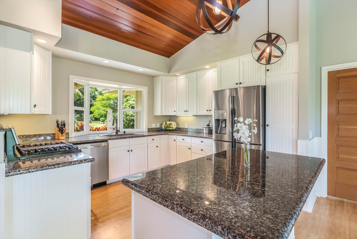4321 Kapuna Road, Unit D Kilauea, HI 96754 - Photo 3 of 23 a kitchen with stainless steel appliances granite countertop a sink a stove and refrigerator