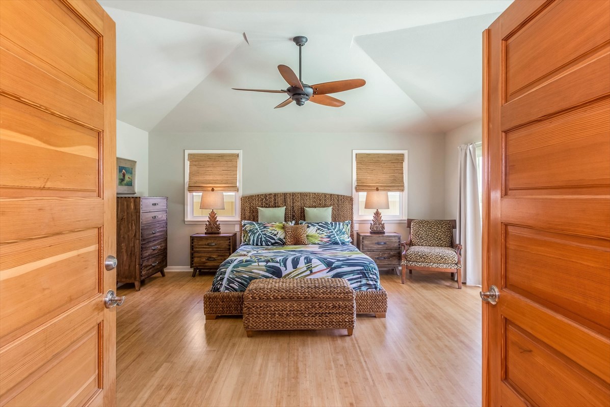 4321 Kapuna Road, Unit D Kilauea, HI 96754 - Photo 9 of 23 a bedroom with a bed and wooden floor