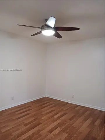 a view of an empty room and a window