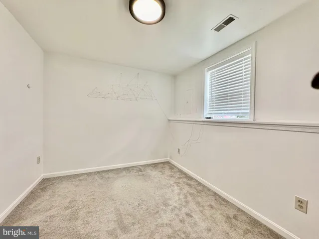 a bathroom with a granite countertop toilet and a sink