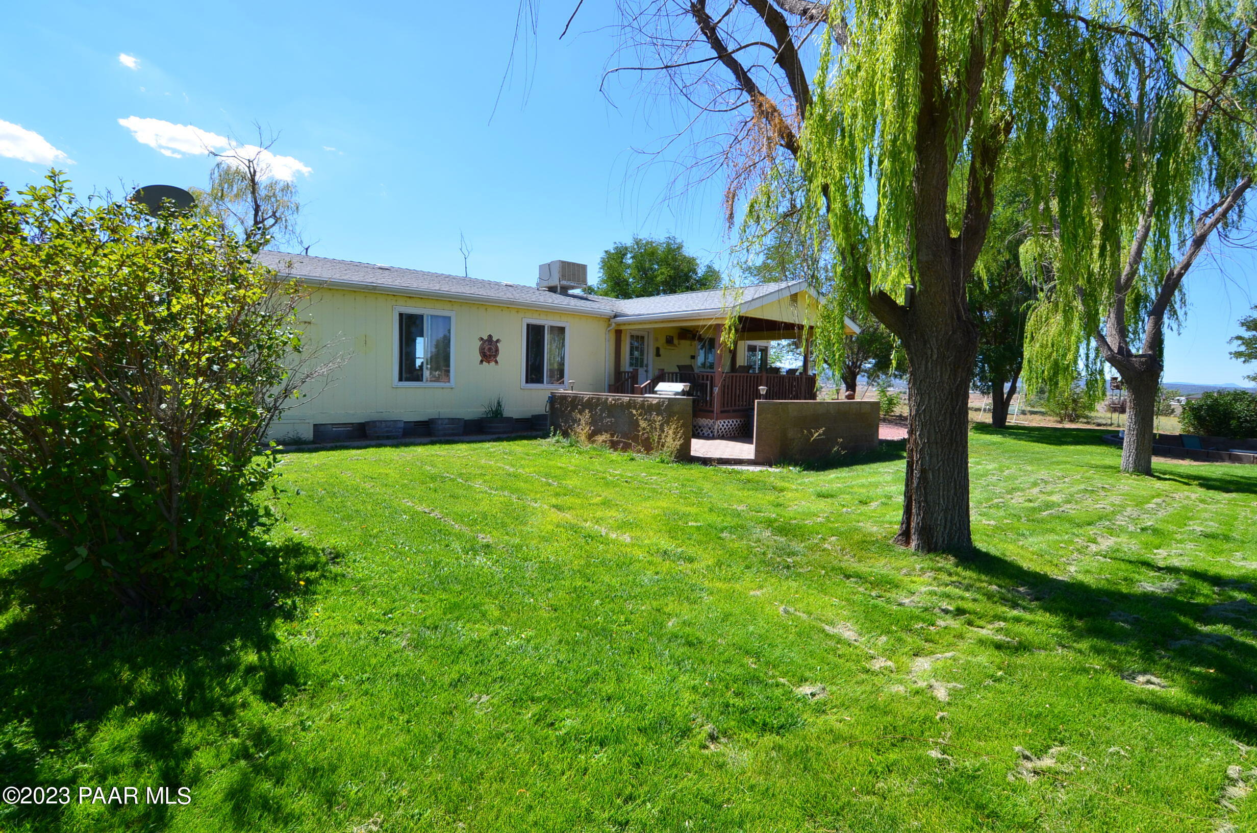 1240 Saddle Road Paulden, AZ 86334 - Photo 11 of 40 a view of a house with a yard deck and a large tree