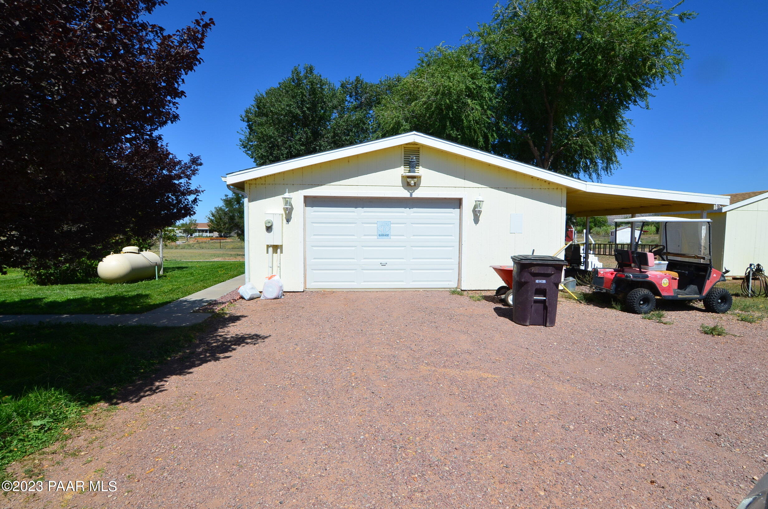 1240 Saddle Road Paulden, AZ 86334 - Photo 20 of 40 a front view of a house with a yard and garage