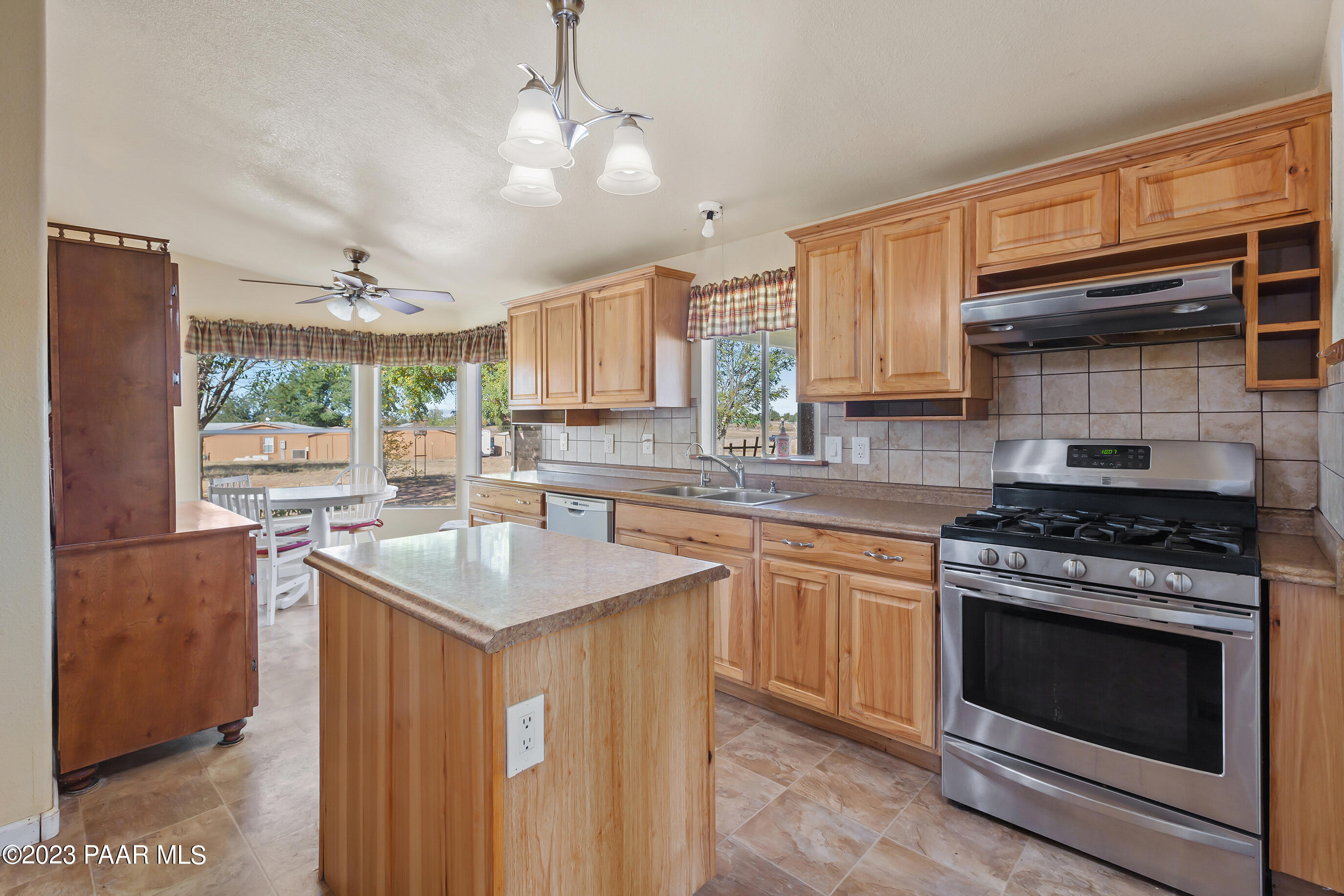 1240 Saddle Road Paulden, AZ 86334 - Photo 24 of 40 a kitchen with stainless steel appliances granite countertop a sink stove and refrigerator
