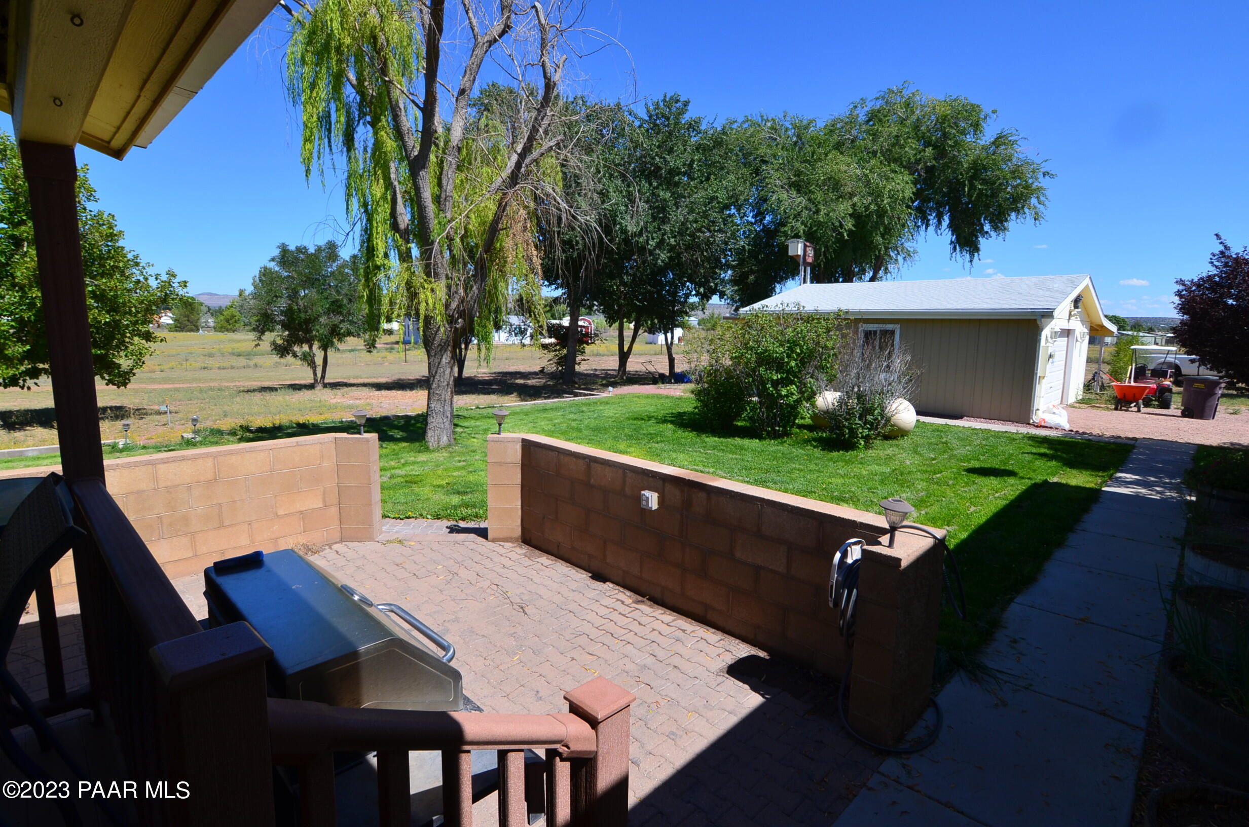 1240 Saddle Road Paulden, AZ 86334 - Photo 35 of 40 a view of a patio with table and chairs potted plants and palm tree