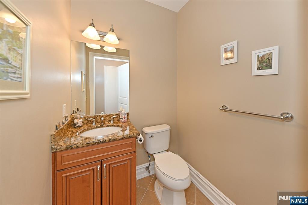 2303 Rio Vista Lane Northvale, NJ 07647 - Photo 12 of 30 a bathroom with a granite countertop sink toilet and mirror