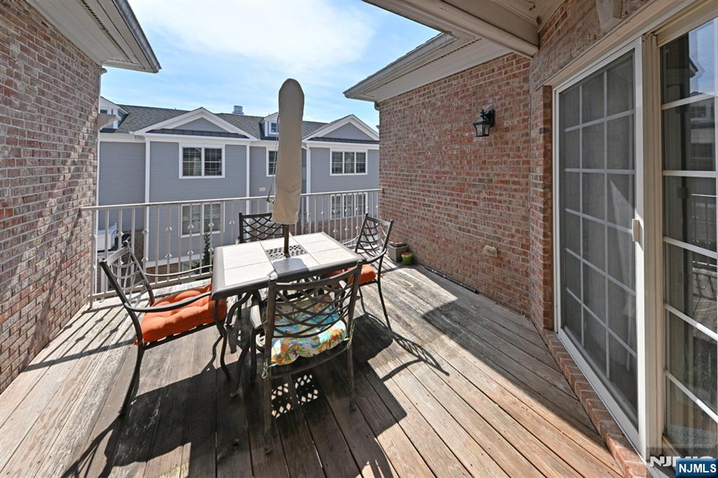 2303 Rio Vista Lane Northvale, NJ 07647 - Photo 16 of 30 a balcony with chairs and wooden floor