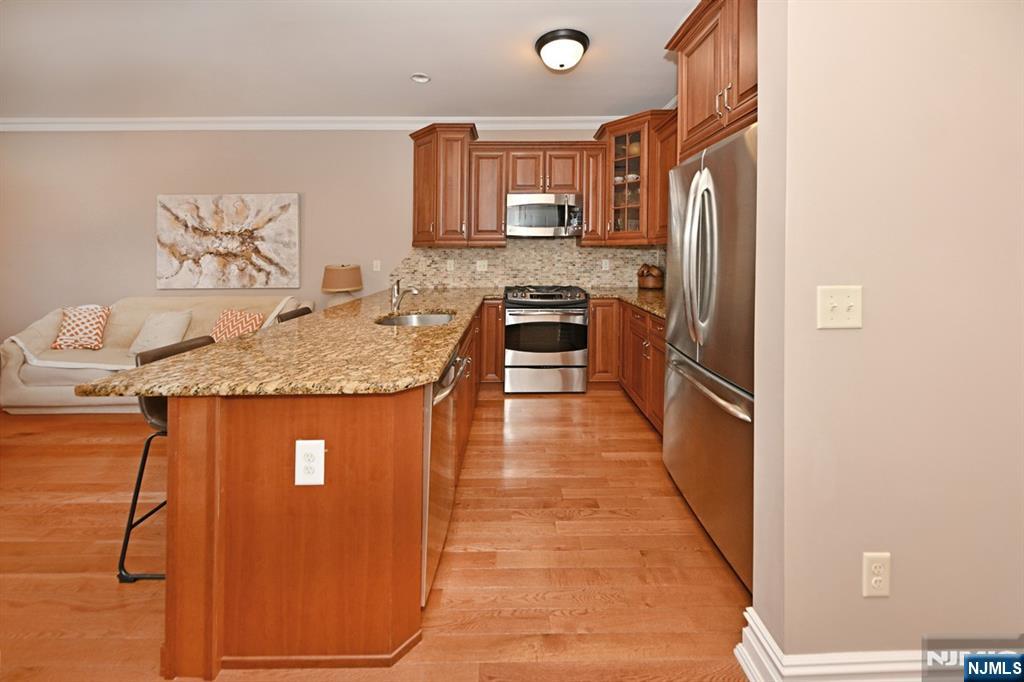 2303 Rio Vista Lane Northvale, NJ 07647 - Photo 8 of 30 a kitchen with stainless steel appliances granite countertop a stove a sink and a refrigerator
