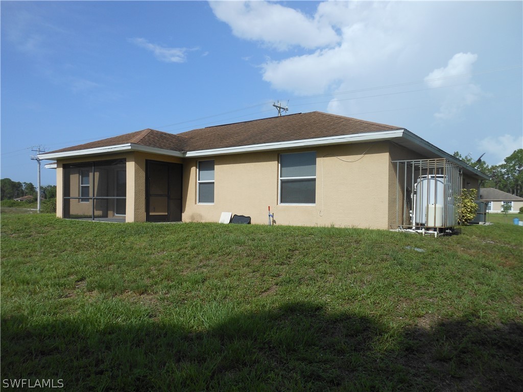 765 Homestead Road South Lehigh Acres, FL 33974 - Photo 3 of 20 a front view of house with yard and green space