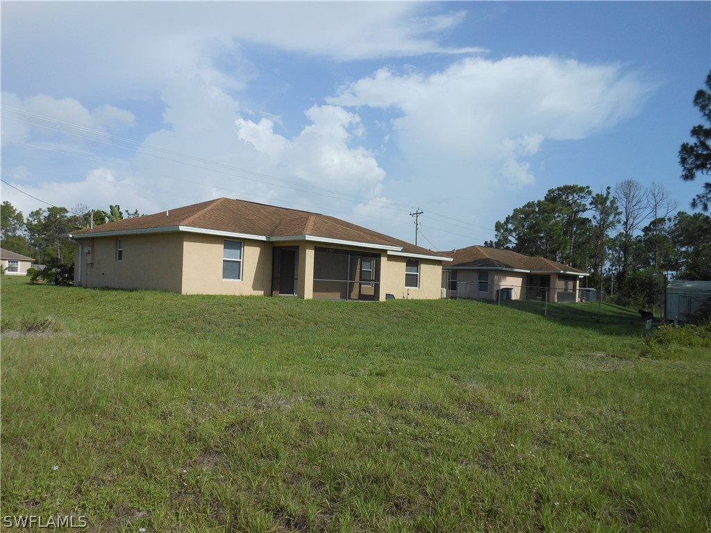 765 Homestead Road South Lehigh Acres, FL 33974 - Photo 5 of 20 a front view of a house with a garden