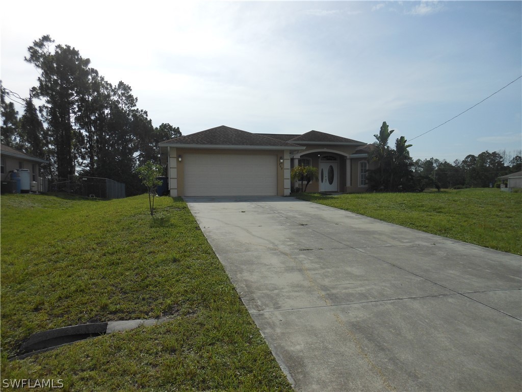 765 Homestead Road South Lehigh Acres, FL 33974 - Photo 10 of 20 a front view of a house with a yard