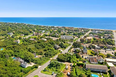 an aerial view of residential houses with outdoor space and street view