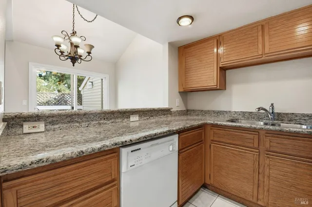 a kitchen with granite countertop cabinets and window