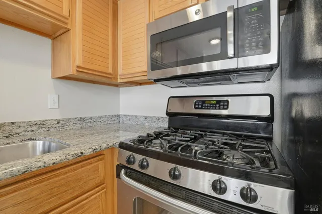 a stove top oven sitting inside of a kitchen