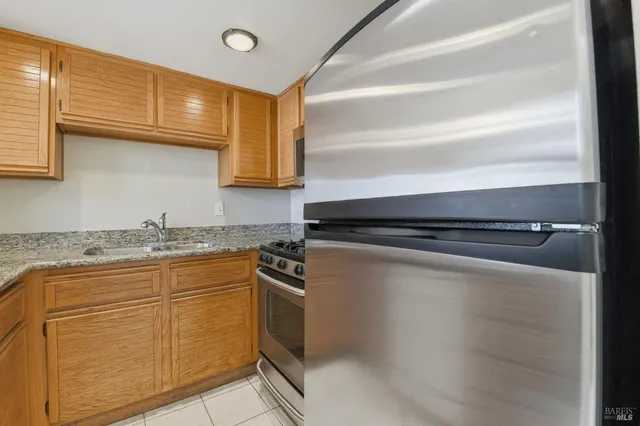 a kitchen with granite countertop a stove and a sink