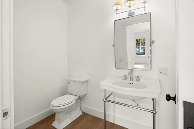 a bathroom with a sink mirror and toilet
