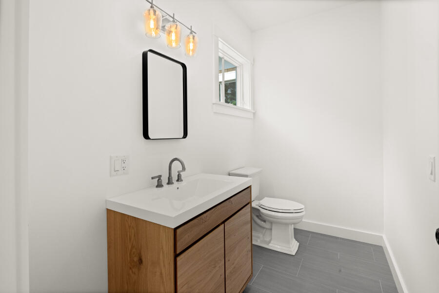 34 Davis Street Vineyard Haven, MA 02568 - Photo 15 of 26 a bathroom with a toilet sink and mirror