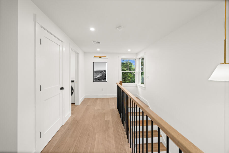 34 Davis Street Vineyard Haven, MA 02568 - Photo 20 of 26 a view of a hallway with wooden floor and windows