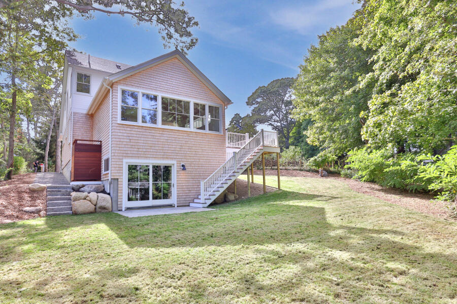 34 Davis Street Vineyard Haven, MA 02568 - Photo 4 of 26 a view of a house with a yard and plants