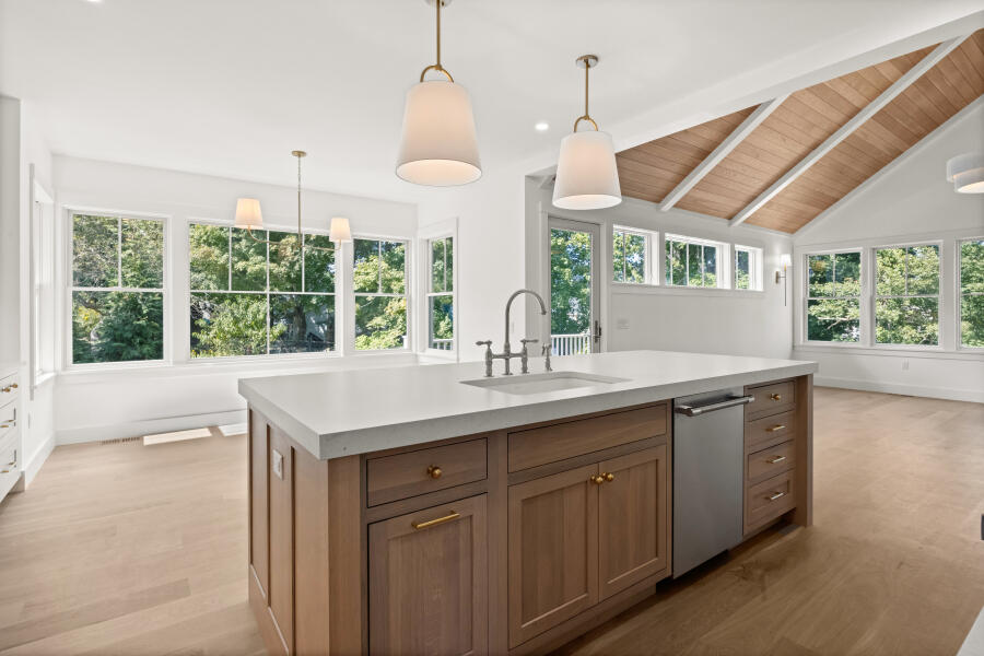34 Davis Street Vineyard Haven, MA 02568 - Photo 7 of 26 a kitchen with kitchen island a large window cabinets a sink and stainless steel appliances