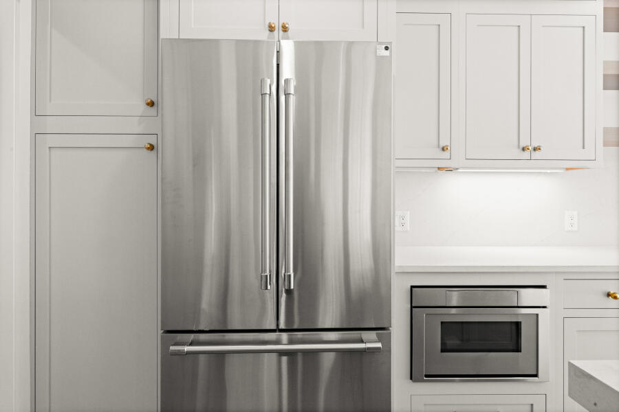 34 Davis Street Vineyard Haven, MA 02568 - Photo 9 of 26 a view of a kitchen with white cabinets and stainless steel appliances