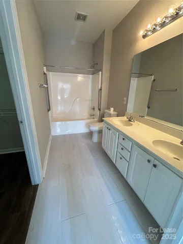 a bathroom with a sink a large mirror and a shower