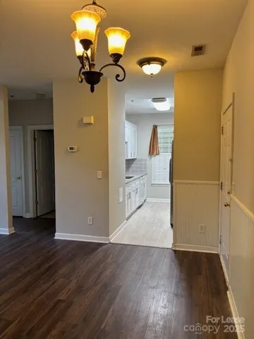 a view of a living room with wooden floor
