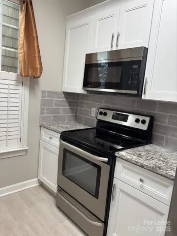 a kitchen with a stove and a microwave