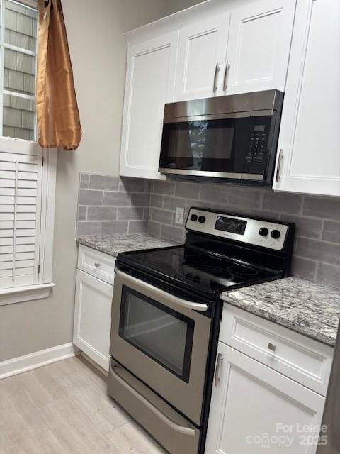18605 Ruffner Drive, Unit 1D Cornelius, NC 28031 - Photo 8 of 14 a kitchen with a stove and a microwave