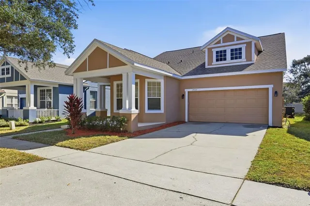 a front view of a house with a yard and garage