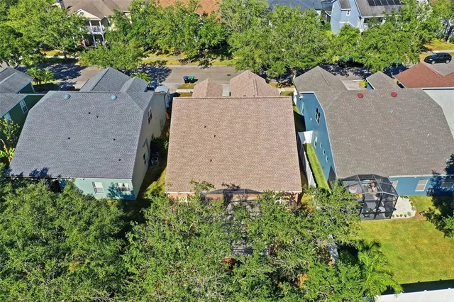 an aerial view of city and lake with boats and trees all around