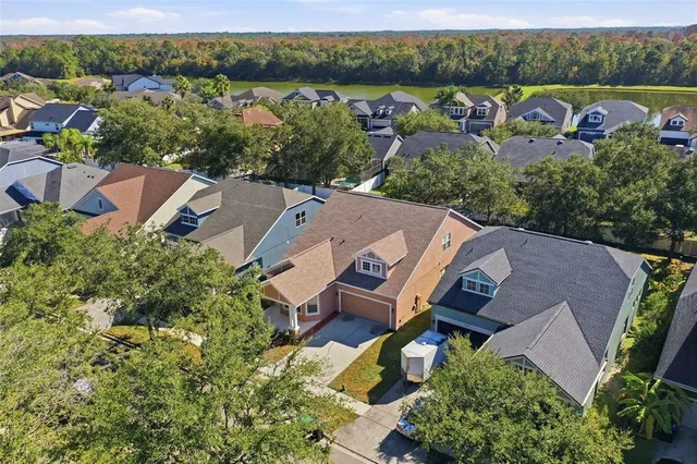 an aerial view of a house with yard swimming pool and outdoor seating
