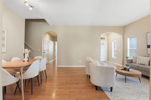 a view of a a dining room with furniture window and wooden floor
