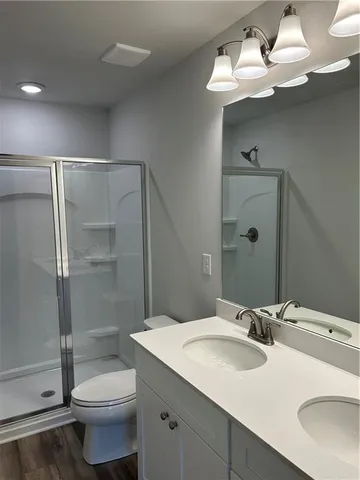 a bathroom with a sink toilet and shower