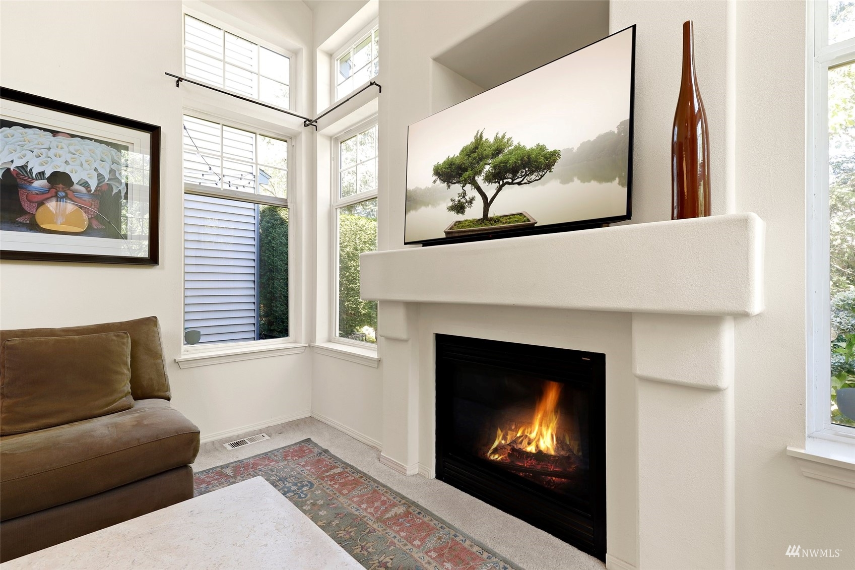4620 Northeast 6th Place Renton, WA 98059 - Photo 8 of 38 a living room with a fireplace and a painting on the wall