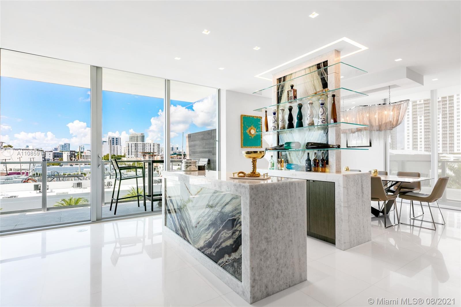 1201 20th Street, Unit PH08 Miami Beach, FL 33139 - Photo 1 of 28 a living room with stainless steel appliances kitchen island granite countertop a table and chairs