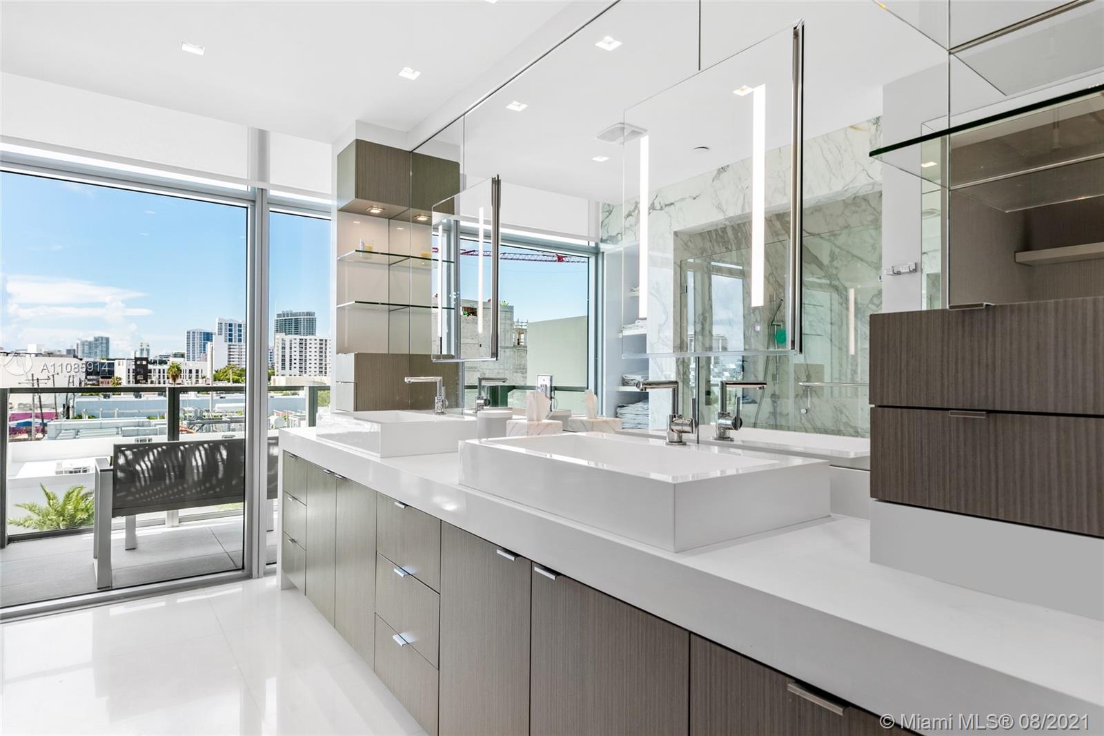 1201 20th Street, Unit PH08 Miami Beach, FL 33139 - Photo 15 of 28 a kitchen with stainless steel appliances a sink and a refrigerator