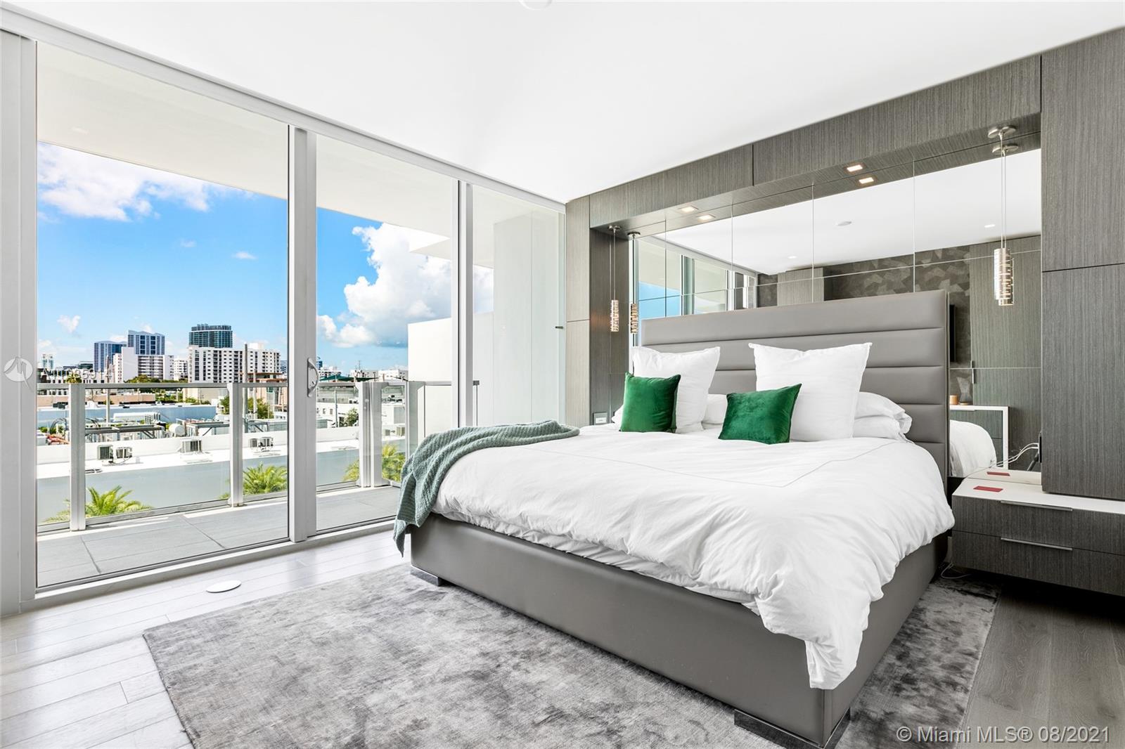 1201 20th Street, Unit PH08 Miami Beach, FL 33139 - Photo 18 of 28 a bedroom with a large bed and a large window