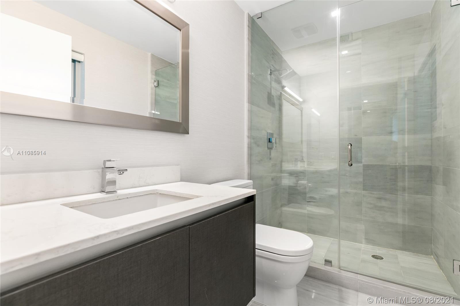 1201 20th Street, Unit PH08 Miami Beach, FL 33139 - Photo 7 of 28 a bathroom with a sink a toilet and shower