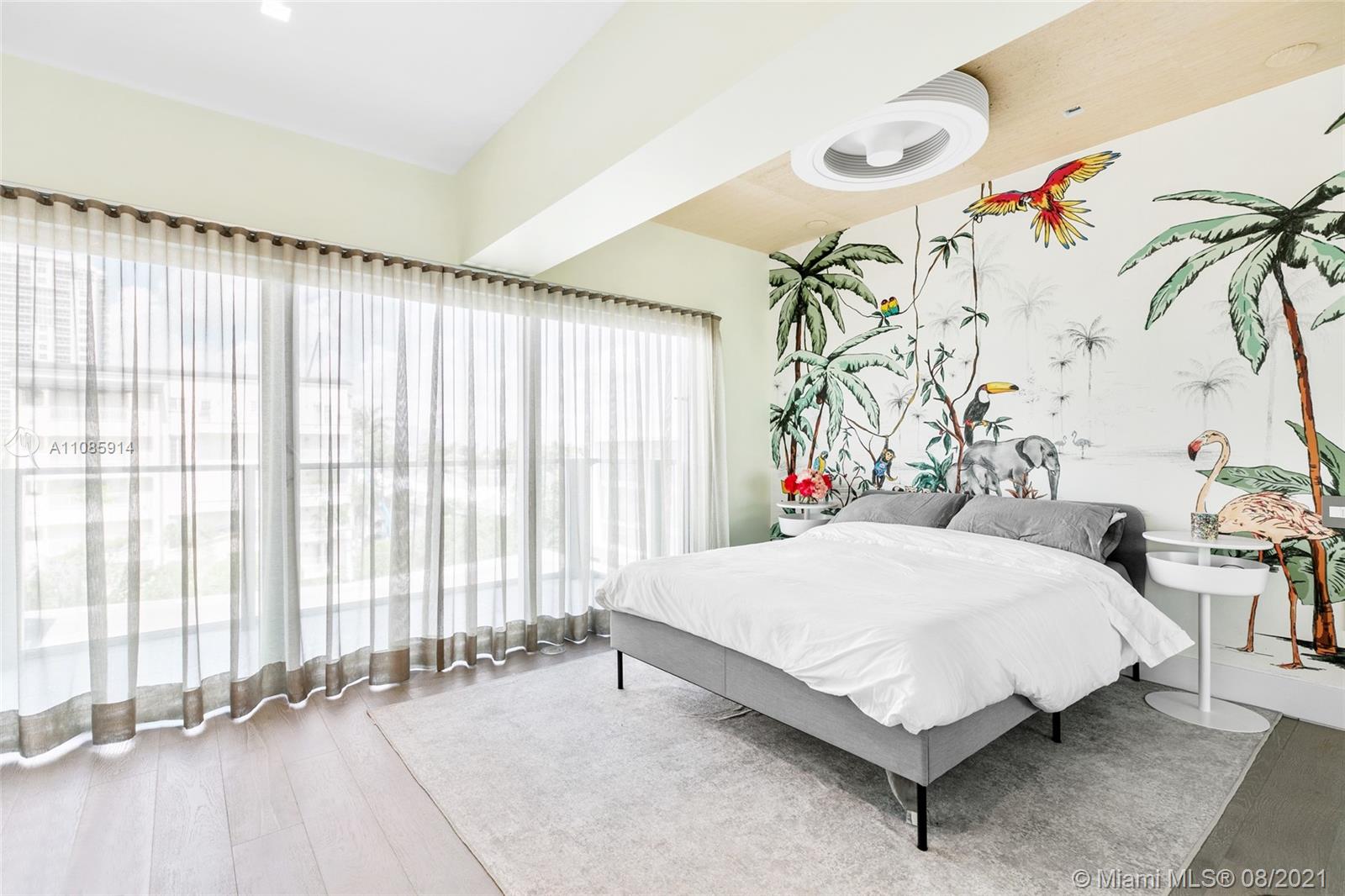 1201 20th Street, Unit PH08 Miami Beach, FL 33139 - Photo 8 of 28 a bedroom with a bed and a table with potted plants